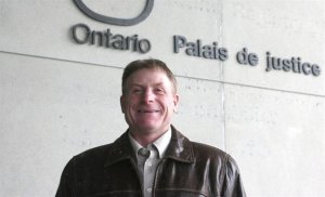 The Canadian Press - Shawn Drennan, part of a four-family fight against Ontario's wind-turbine legislation, is seen outside court in London, Ont., on Monday, Nov. 17, 2014. THE CANADIAN PRESS/Colin Perkel 