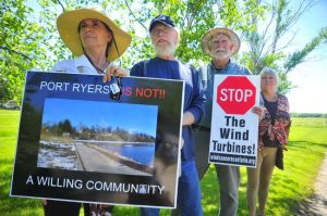 Port Ryerse residents protested as members of an environmental tribunal hearing into the case of wind turbines proposed for a field next to their village visited the site on Wednesday, June 3, 2015. From left to right are: Mary Goodlet, Bill Irvin, Stew Smith, and Shana Greatrix. (DANIEL R. PEARCE Simcoe Reformer)